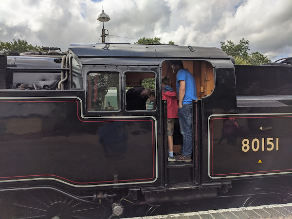Myself and the boys in the cab of a steam engine looking into the firepit feeling suitably awed