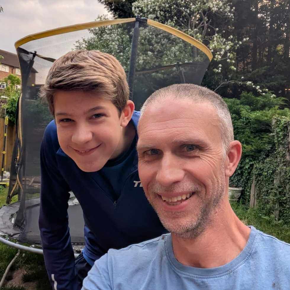 A photograph of me with a freshly shaved head, courtesy of my boys - one of whom is sat behind me