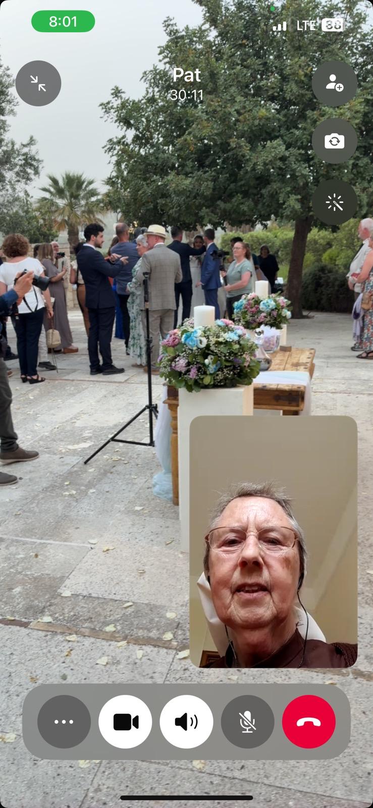 A screenshot of Pat watching the wedding on a WhatsApp video call